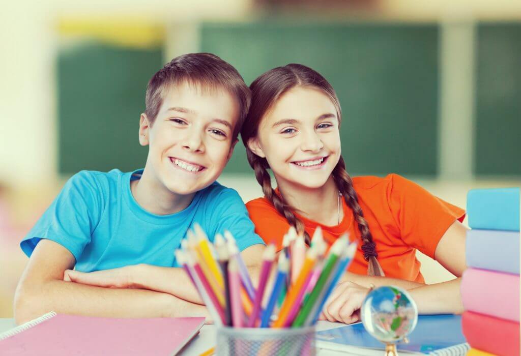two kids smiling at school
