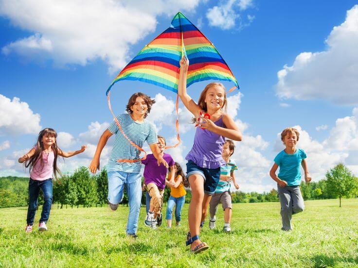 children flying kite in park