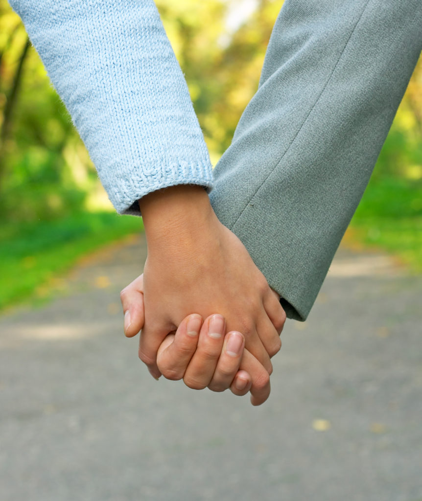 approach of a couple's clasped hands