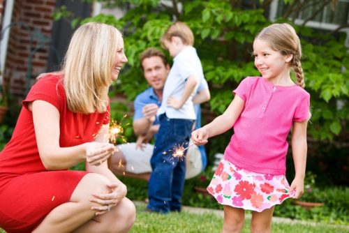 parents playing with kids and sparklers