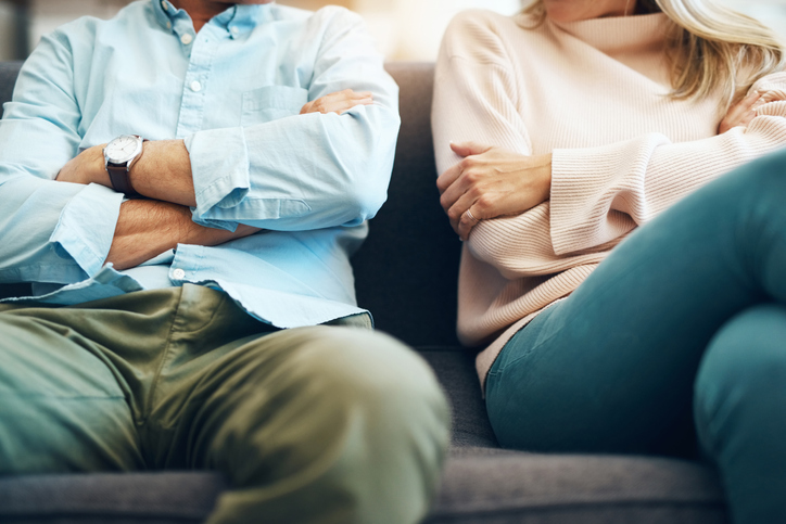 couple on couch crossed arms