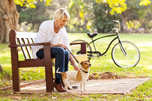 woman on square's bench with dog