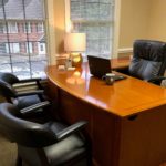 desk with two black armchairs in office of Marietta 
