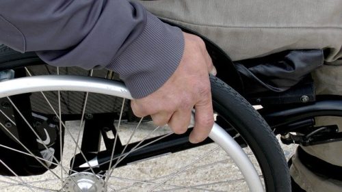 SSA Disability Benefits Lawyer, hand on a wheelchair
