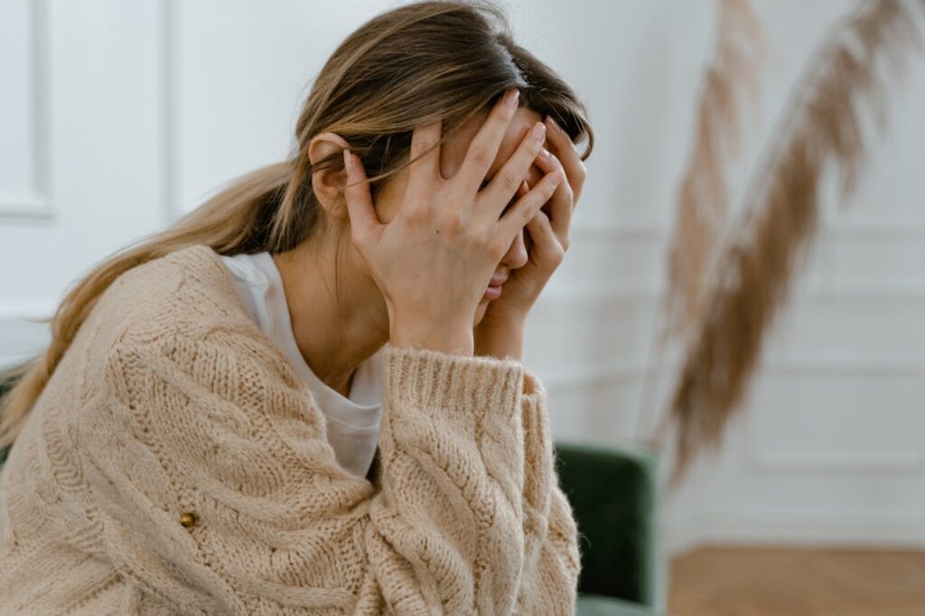 distressed woman covering face